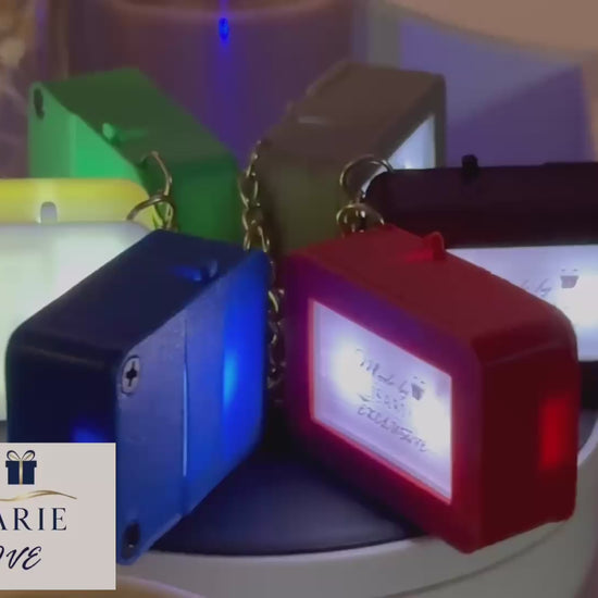 A video showcasing the 'Made By LisaMarie' Exclusive Keychain Box in red, green, blue, gray, black, and white, displayed on a revolving table to highlight each colors sleek design. The Made By LisaMarie logo is elegantly placed in the corner, with gentle piano music enhancing the sophisticated presentation.