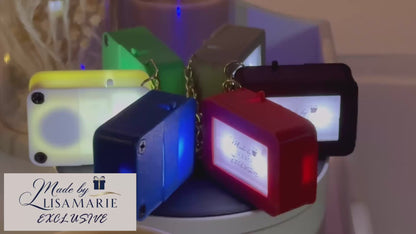 A video showcasing the 'Made By LisaMarie' Exclusive Keychain Box in red, green, blue, gray, black, and white, displayed on a revolving table to highlight each colors sleek design. The Made By LisaMarie logo is elegantly placed in the corner, with gentle piano music enhancing the sophisticated presentation.